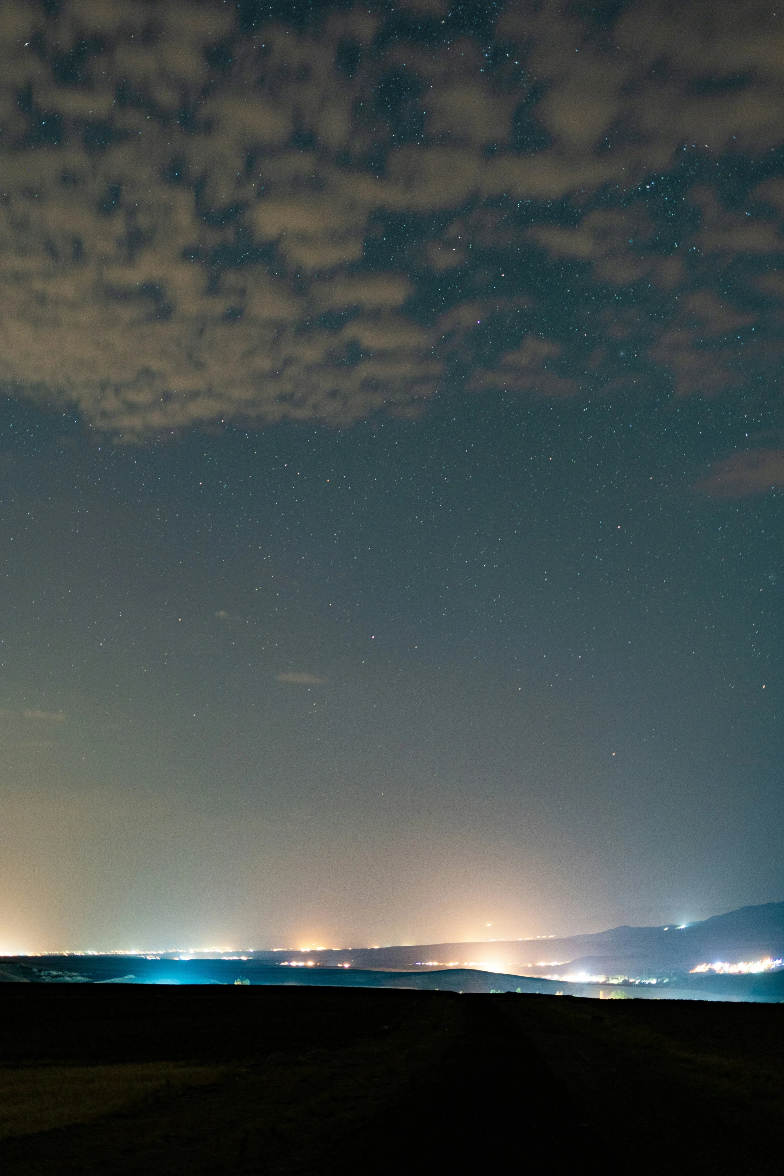 a long exposure of a night time scene with stars