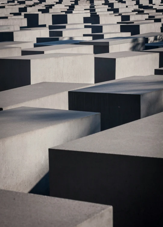 rows of stone benches with black benches behind them