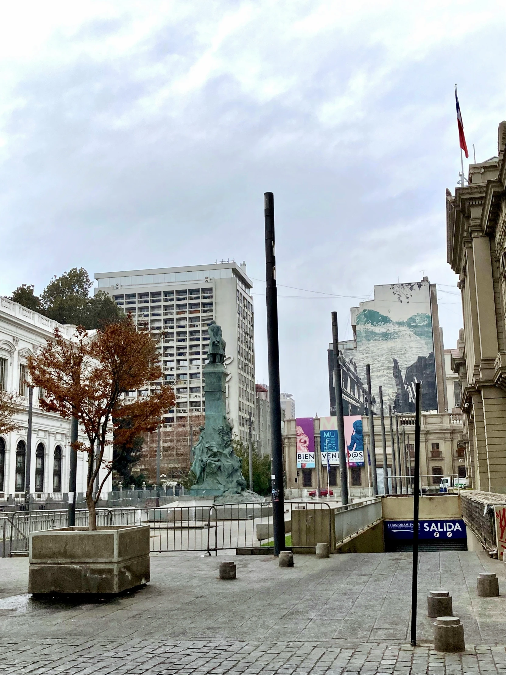 there are a few buildings in the background and a large statue on the left