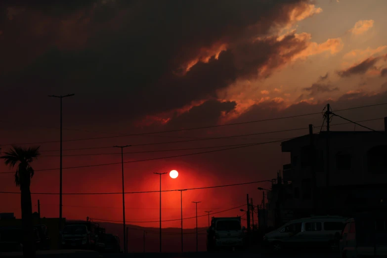 sunset behind a bunch of power lines and buildings