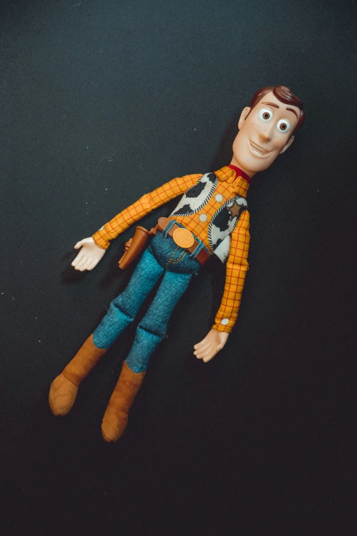 a toy figure with glasses, yellow shirt and jeans