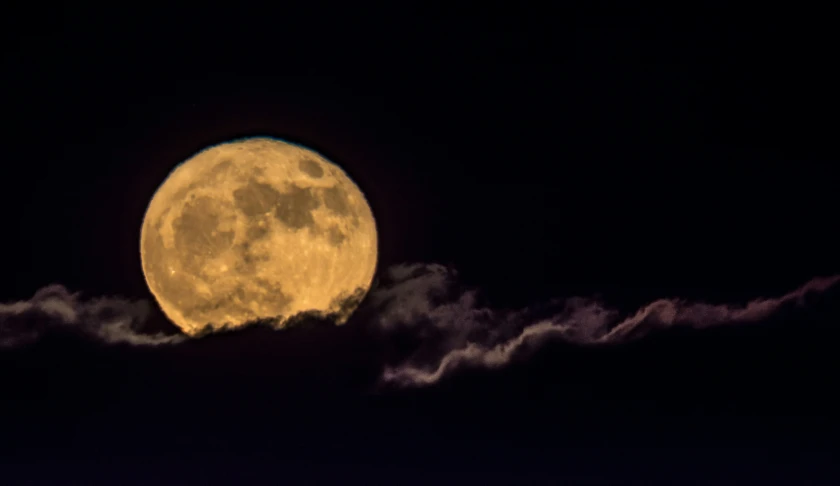 a very large moon in the sky during the day