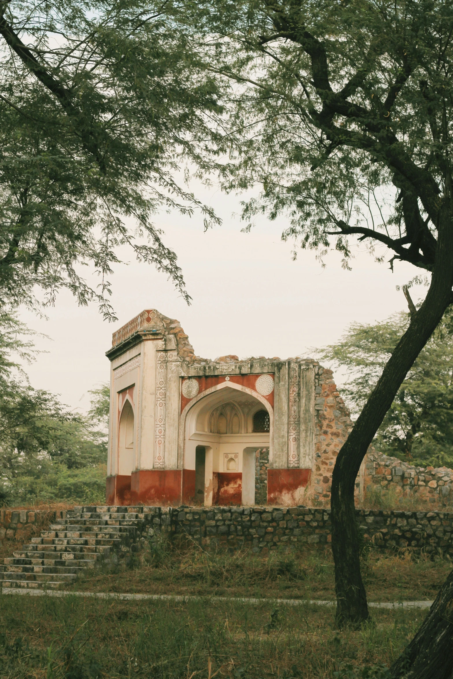 a stone building has been crumbling into two parts