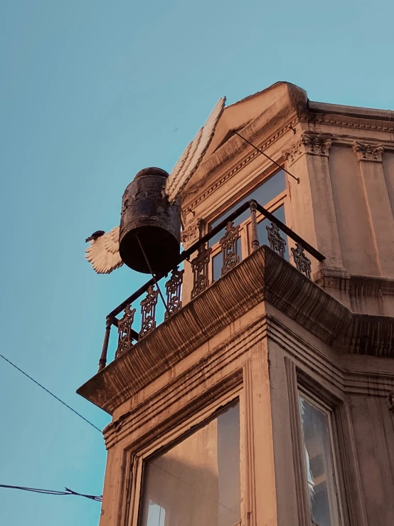 an old building with a black bell and clock