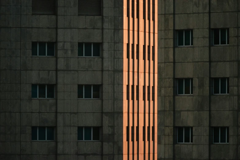 a tall building with multiple windows next to it