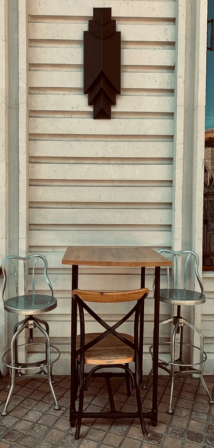 a table with two chairs and a chair for one