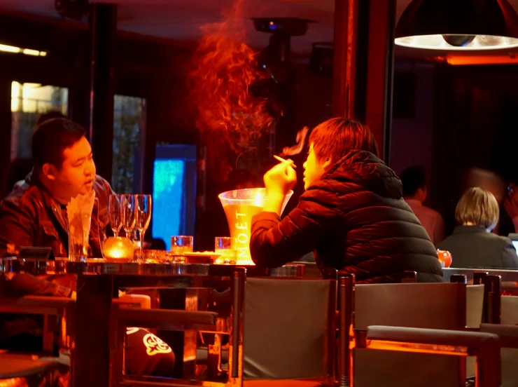 a man is feeding a woman a piece of food at the table