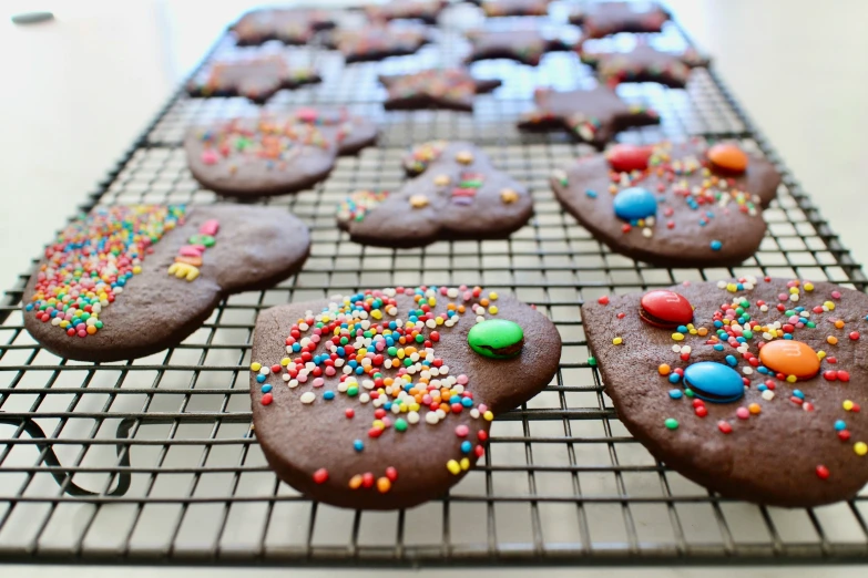 the cookies are covered with sprinkles and rainbow colored candies