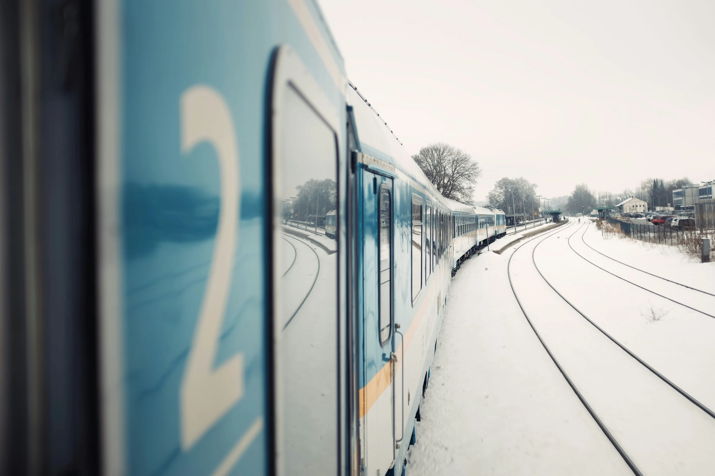 a train sits in the snow on tracks