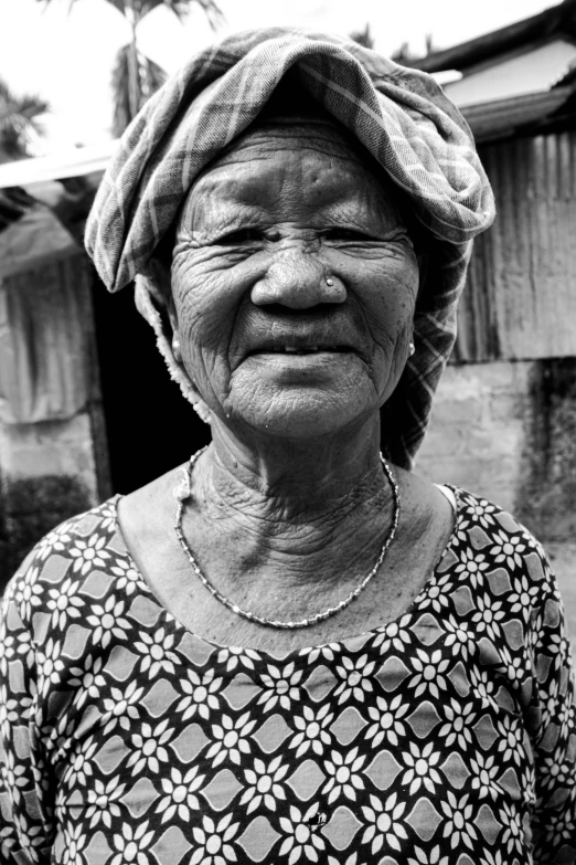 an old woman wearing a towel around her head