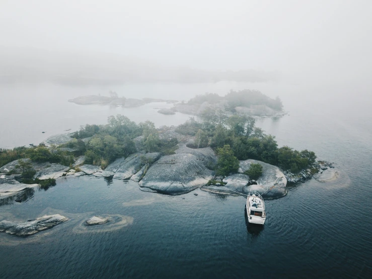 a boat sits on a small island in the water