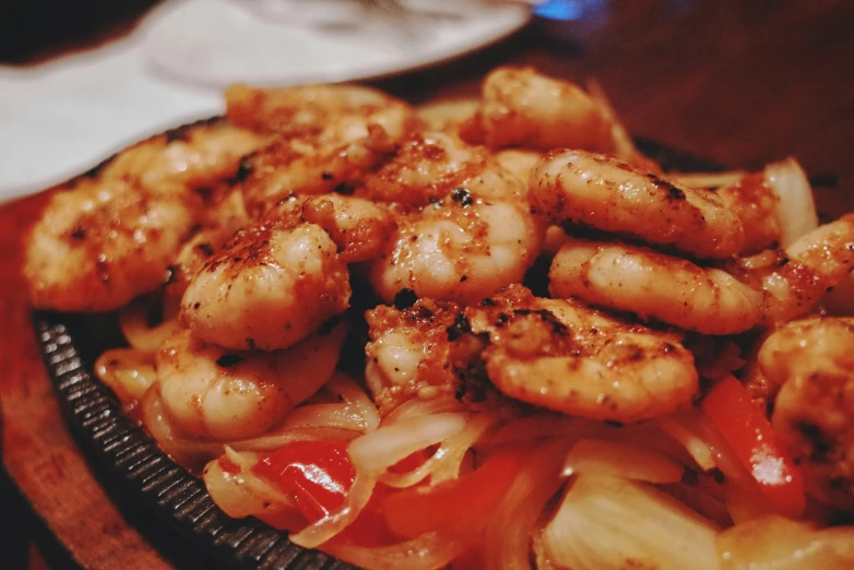 a bowl full of shrimp is being served on a table