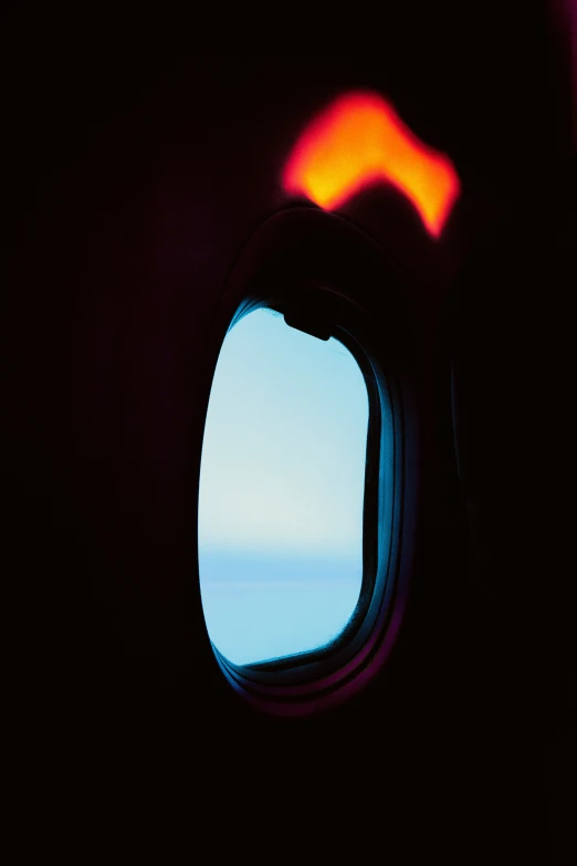 a plane window with some things lit up