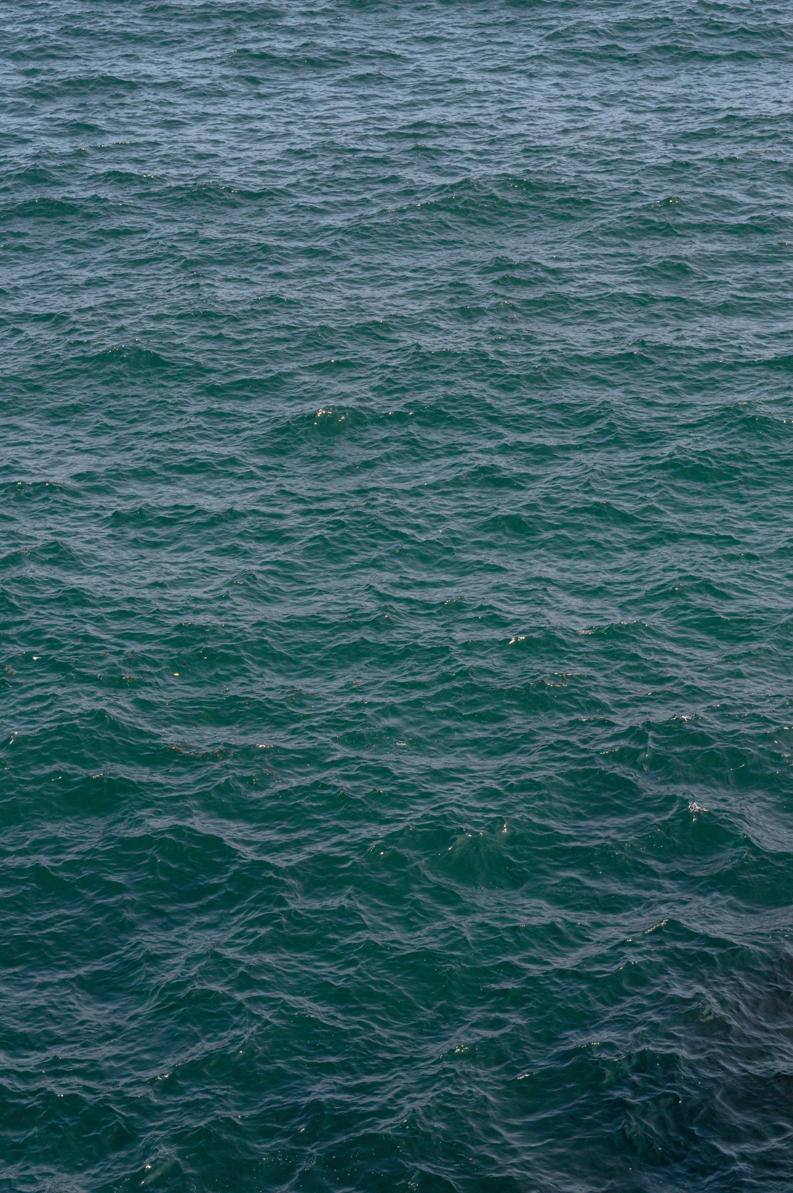 a lone sailboat in the middle of a lake