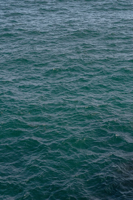 a lone sailboat in the middle of a lake