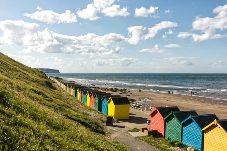 a group of small huts sitting next to a beach