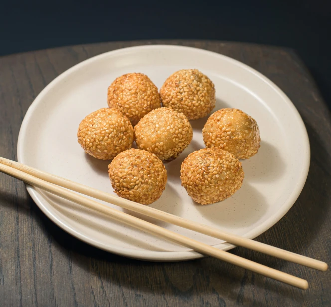 chop sticks sit on a plate of asian food