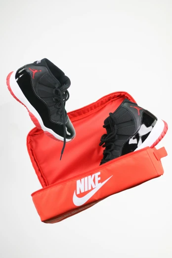 a pair of sneakers laying on top of a duffle bag