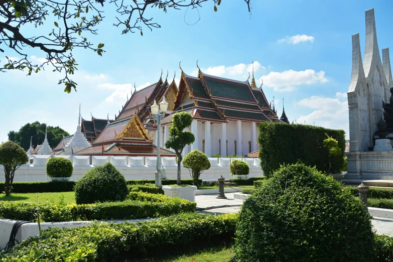 a white temple with lots of trees around it