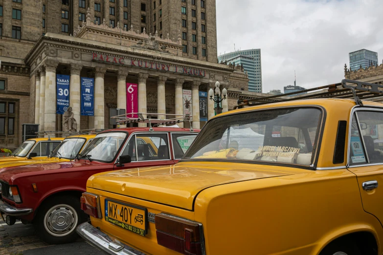 old model taxis lined up in a car museum