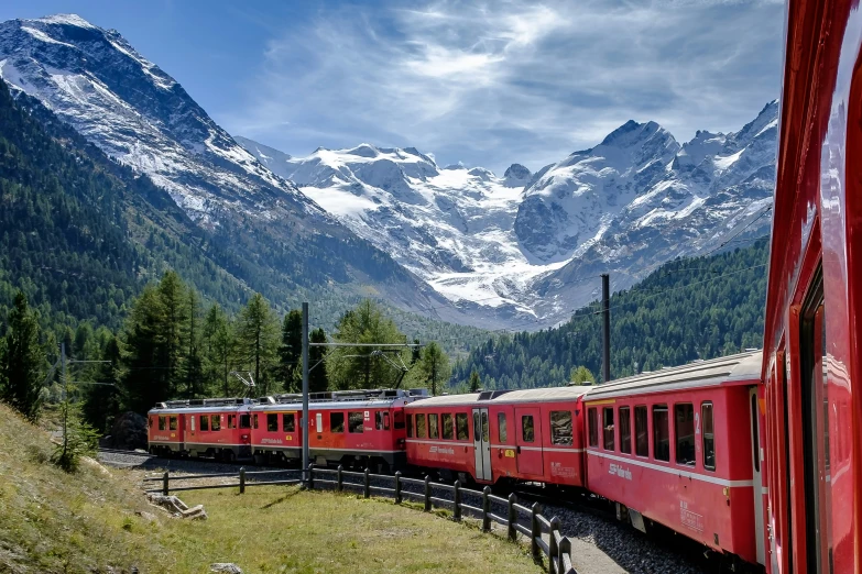 the train passes by a mountain pass through a green valley