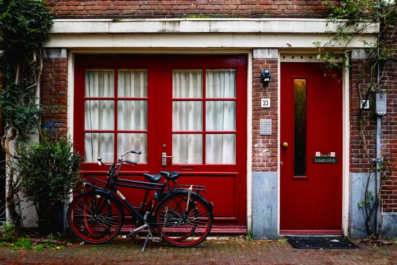 two bikes parked outside of a brick building