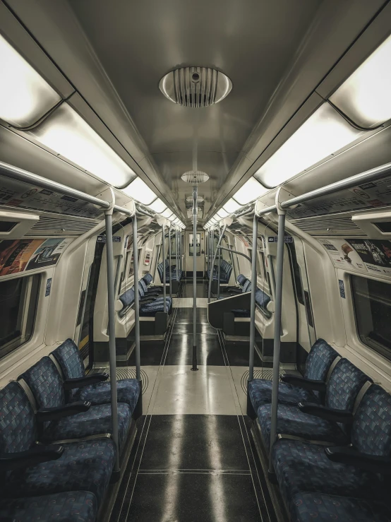 a train car filled with blue seats and lots of windows