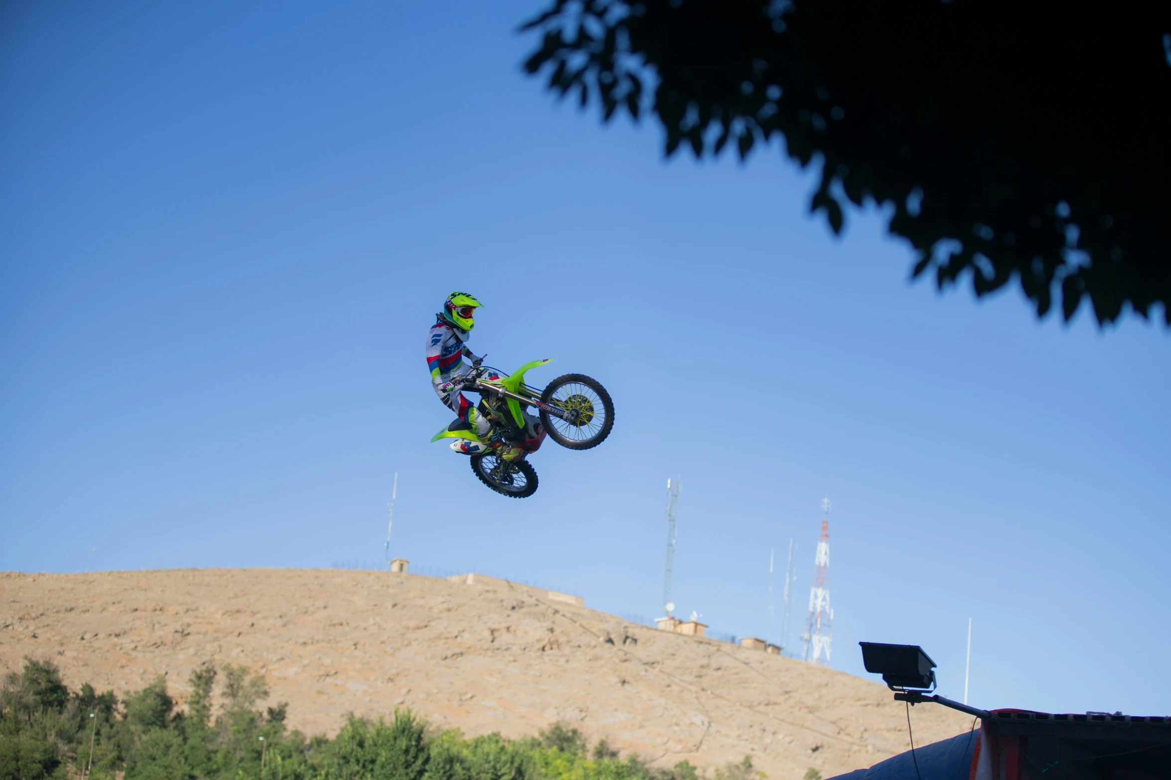 a man on a bike jumping over a hill