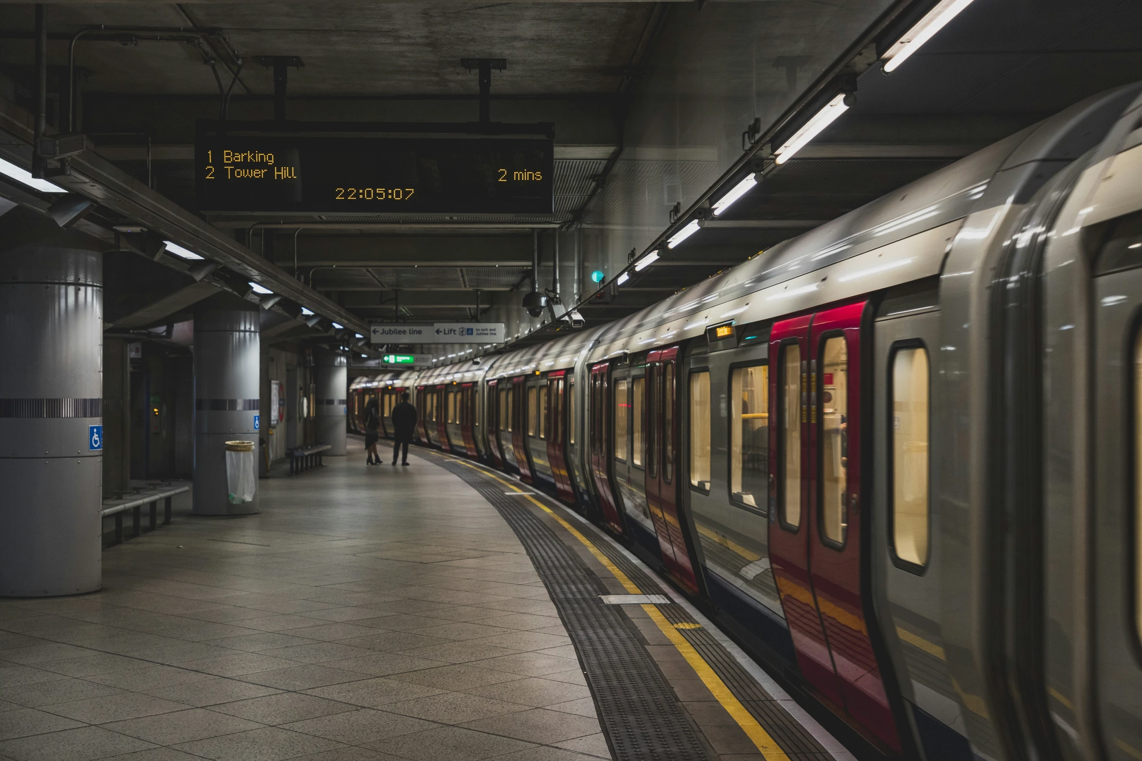 a train stopped in a train station with no people