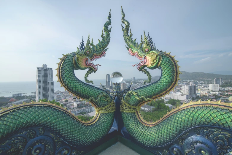 two green dragon sculptures are facing each other