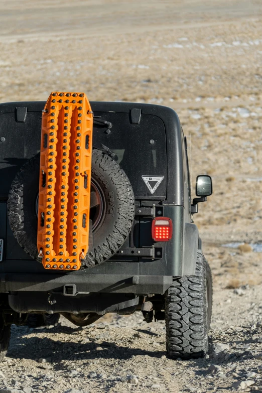 jeep tires, orange tire guards, and bumper are fitted to the back of the car