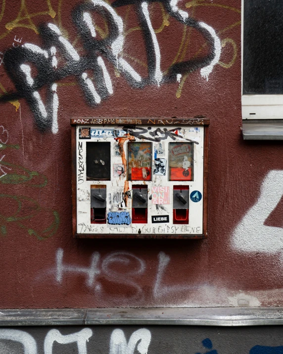 an old red building with some graffiti on it