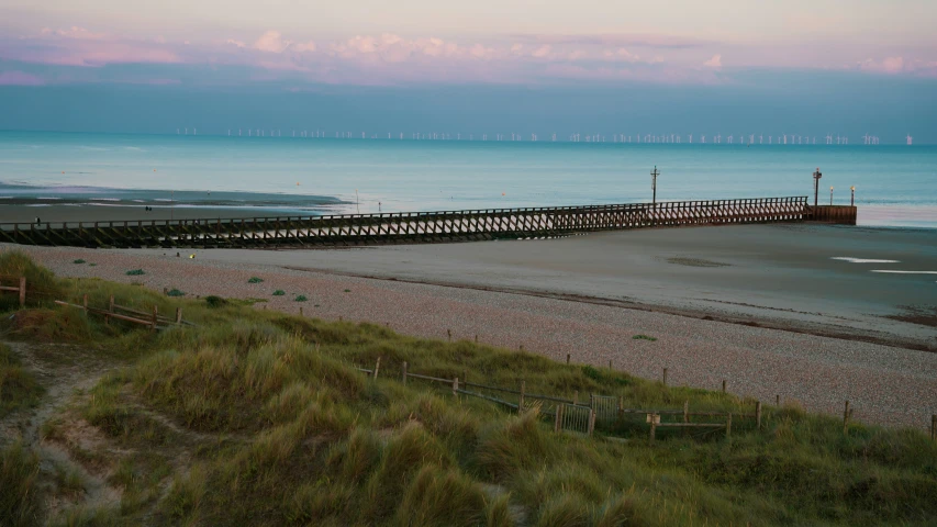 the sea is blue and calm for an incoming tide