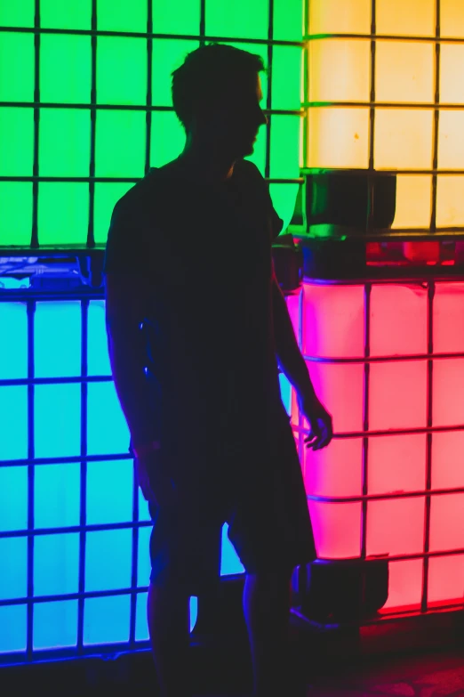 a man stands in front of colored squares