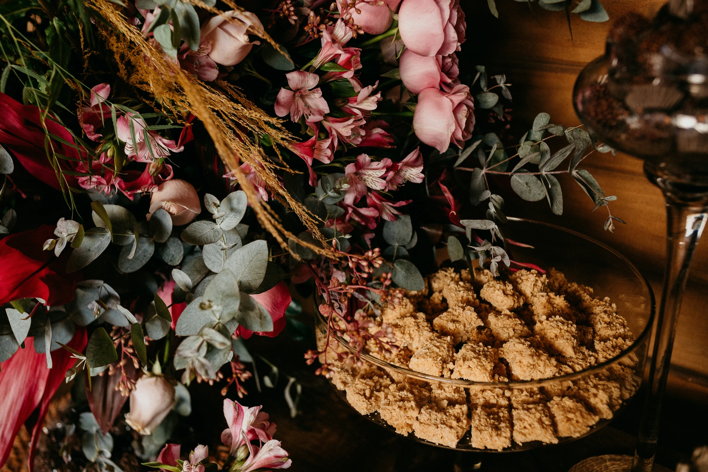 dessert on glass dishes with dried flowers on display