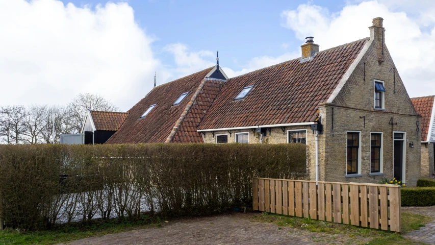 a brick house with the front fence extended