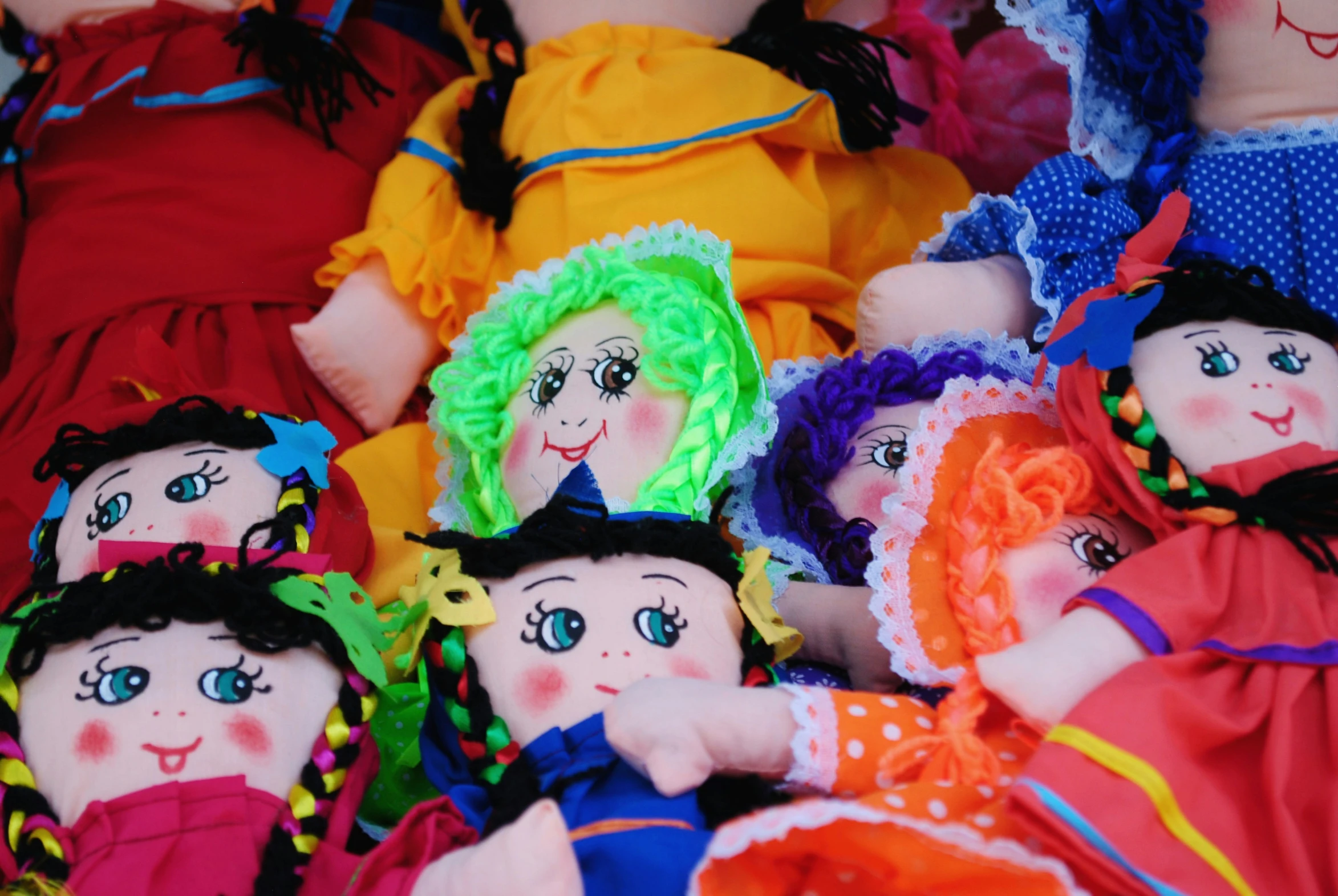 a pile of little dolls on the floor