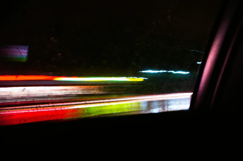 a view out a window at night with blurry lights