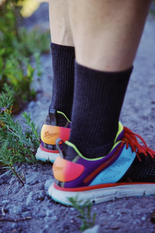 there is someone standing on a trail with his shoes