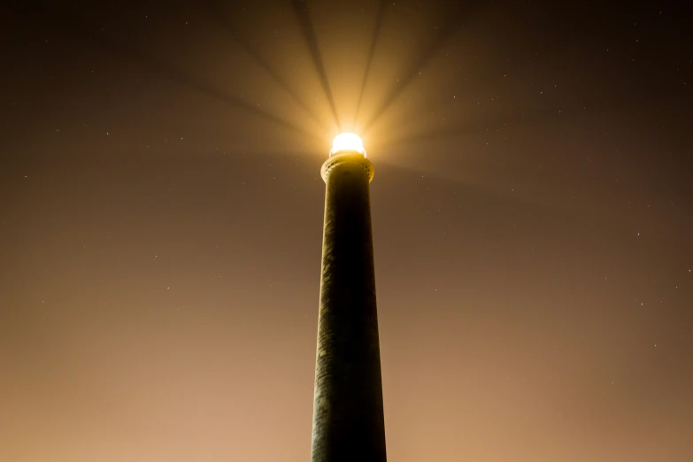 a light is shining down on top of a post