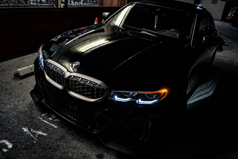 a shiny black bmw on the pavement