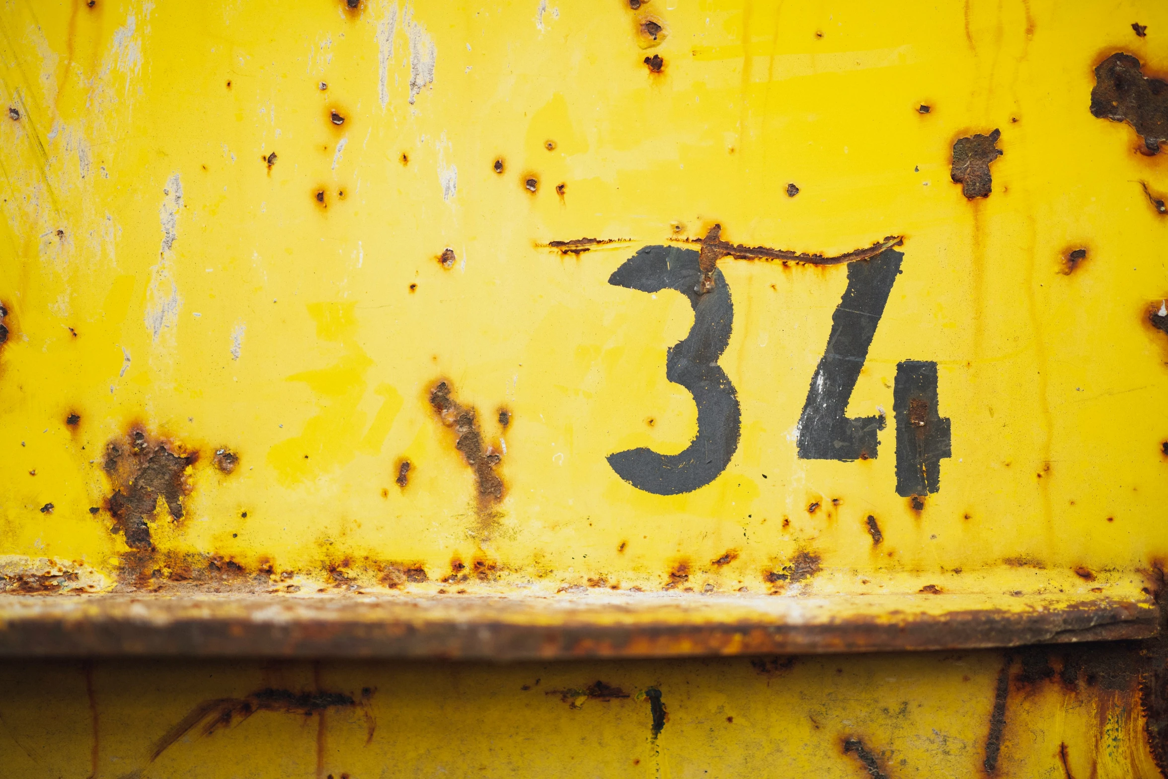 rusty yellow metal casing with number that reads 37