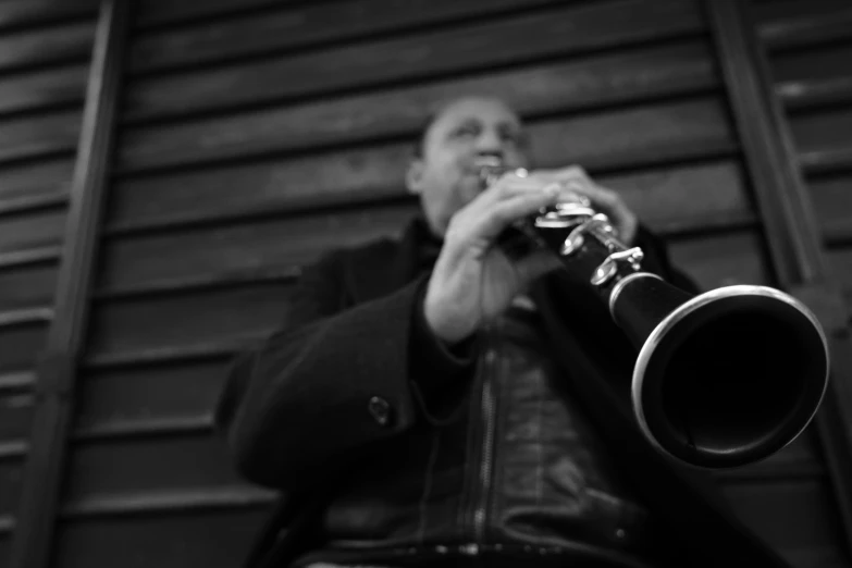 a man in black jacket playing a trumpet
