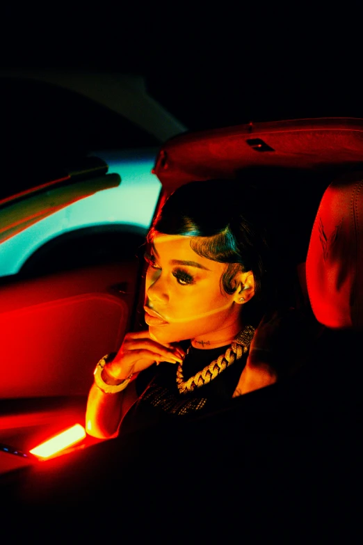 a woman standing next to a car in the dark