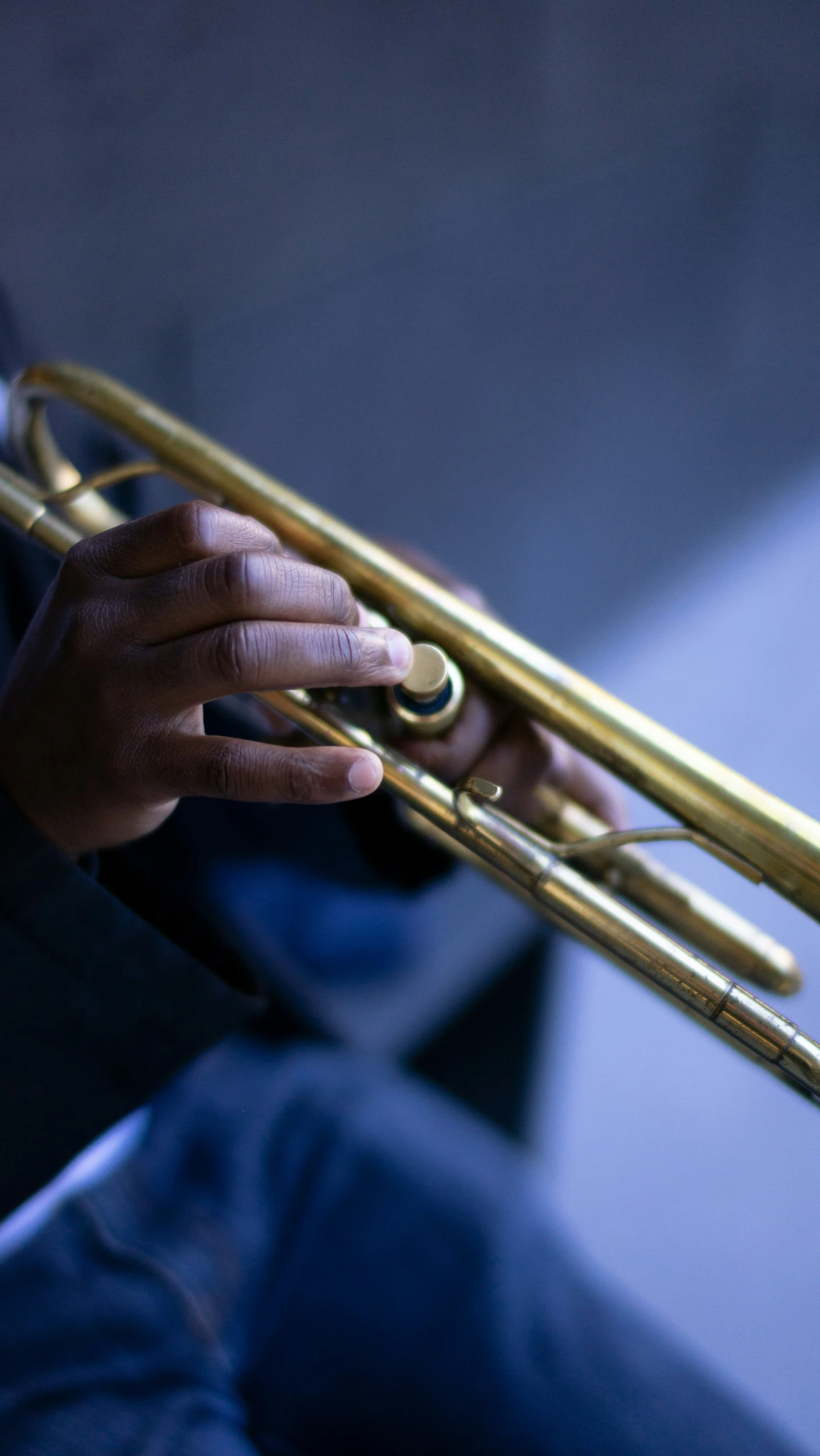 a person is holding a trumpet in his hand