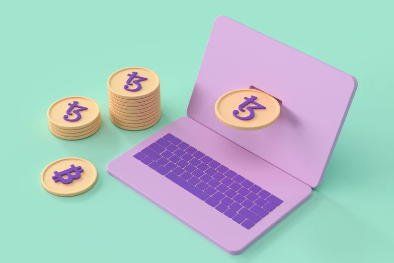 coins with letters and symbol on them sitting next to a purple laptop