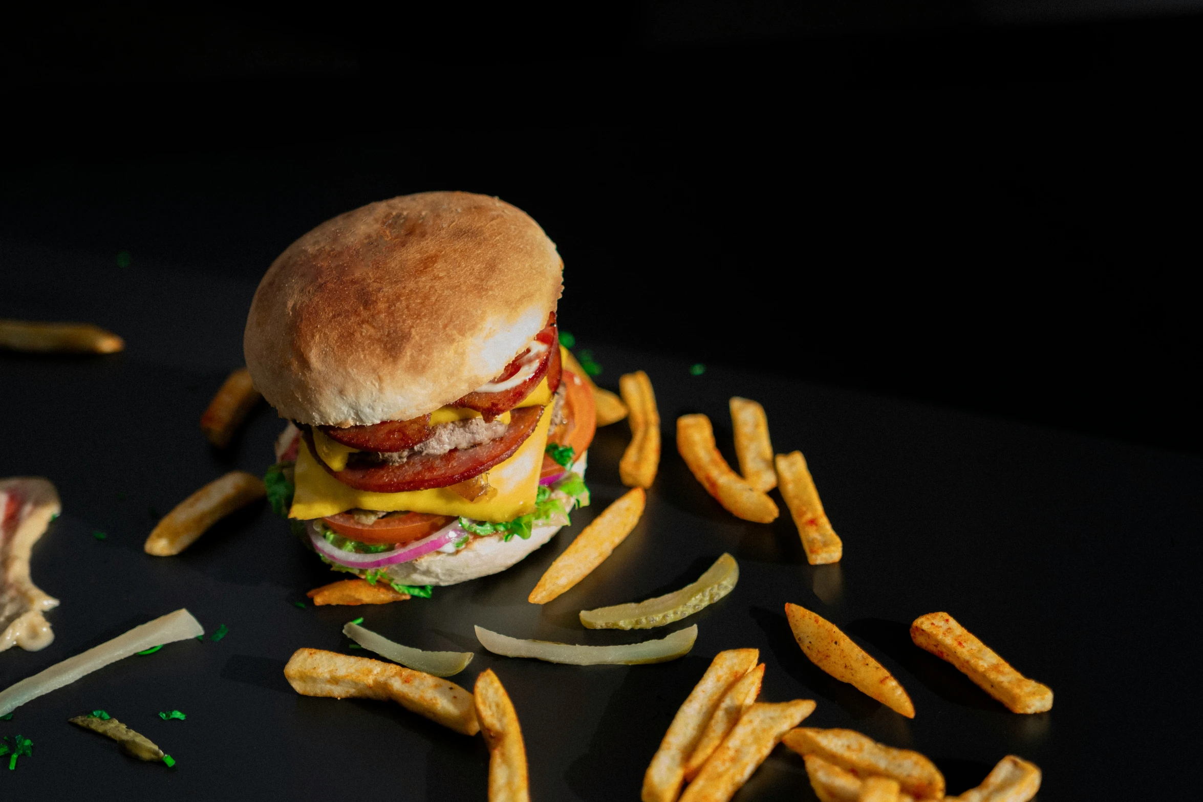 a burger and some french fries sitting on a table