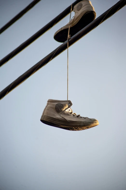 an old pair of shoes hanging from a wire