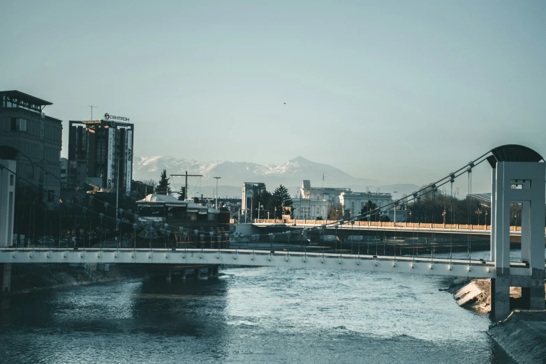 a city sits near a river and there are bridges that cross it