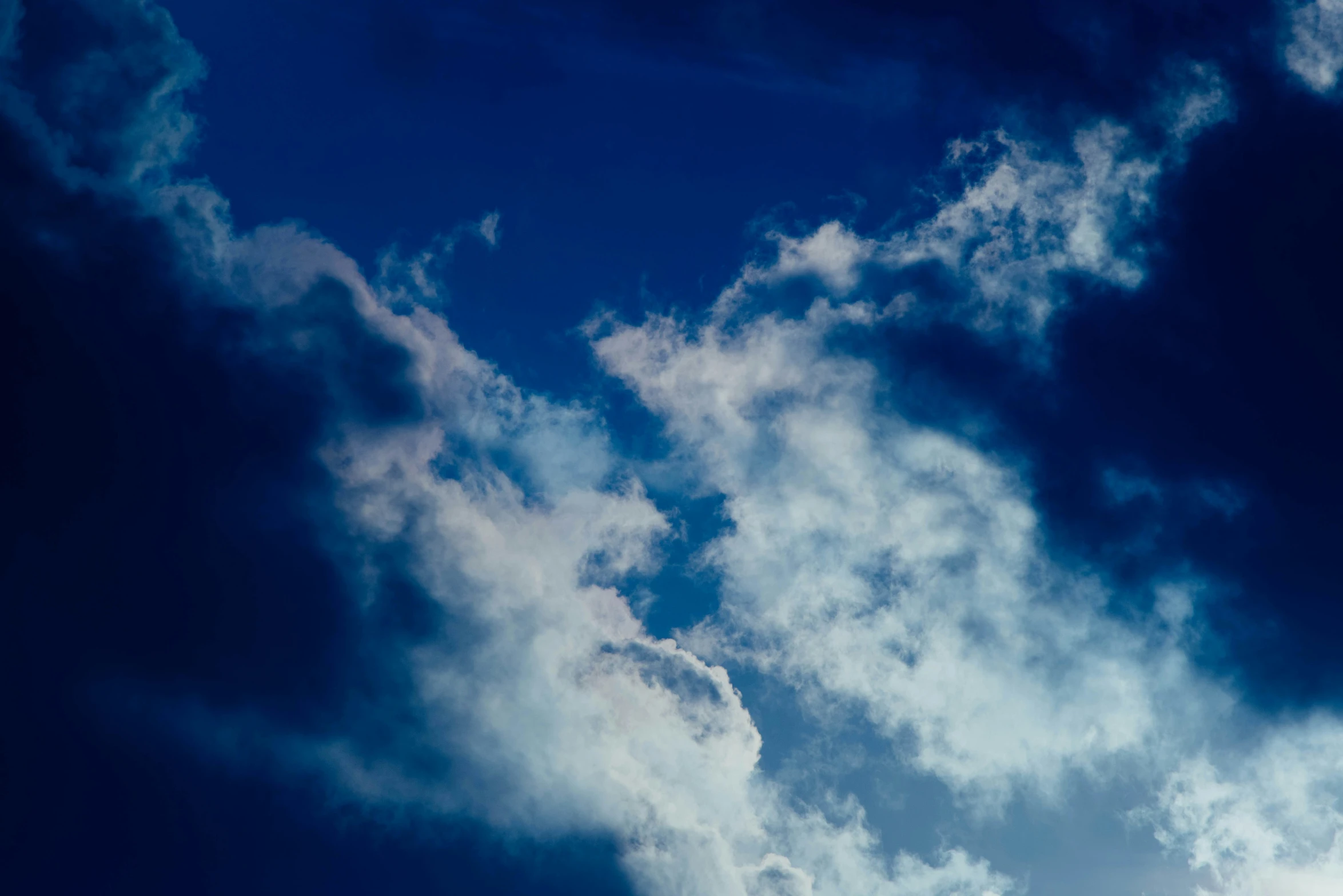 a jet airliner flying through a dark cloudy sky